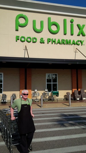 Thomas Swenson in front of publix with grocerey carts